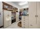 Organized walk-in closet with custom cabinetry, shelving, drawers, and ample storage space at 646 Ruby Trust Dr, Castle Rock, CO 80108