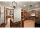 Climate-controlled wine cellar with custom wood racking and tile flooring at 646 Ruby Trust Dr, Castle Rock, CO 80108