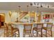 Entertaining bar area featuring granite countertops, wooden barstools and decorative lighting at 2941 Castle Butte Drive Dr, Castle Rock, CO 80109