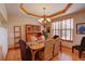 Classic dining room with hardwood floors, elegant chandelier, and large window providing natural light at 2941 Castle Butte Drive Dr, Castle Rock, CO 80109