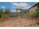 A fenced garden with a wooden gate and a stone patio at 2941 Castle Butte Drive Dr, Castle Rock, CO 80109