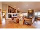Spacious living room with hardwood floors, stone fireplace, built-in shelving, and large windows, perfect for entertaining at 2941 Castle Butte Drive Dr, Castle Rock, CO 80109