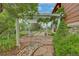 Landscaped backyard featuring a stone patio, walkway, rock garden, and vine-covered pergola at 2941 Castle Butte Drive Dr, Castle Rock, CO 80109
