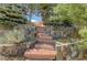 Stone steps leading up to a home surrounded by trees and stone walls at 2941 Castle Butte Drive Dr, Castle Rock, CO 80109