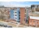 View of the building with blue and gray panels nestled in an urban landscape and cityscape at 2460 W 29Th Ave # 204, Denver, CO 80211