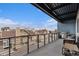 Spacious balcony with grill, seating, and views of the city at 2460 W 29Th Ave # 204, Denver, CO 80211