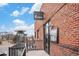 Brick building with a 'linger EATUARIES' sign, offering an outdoor dining area with heaters at 2460 W 29Th Ave # 204, Denver, CO 80211