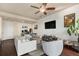 Comfortable living room with modern furniture, TV, and a view of the doorway and office at 2460 W 29Th Ave # 204, Denver, CO 80211