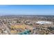 Aerial view of a neighborhood featuring a park, tennis courts, and a frozen lake, near community amenities at 5895 S Huron St, Littleton, CO 80120