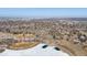 Aerial view of a neighborhood with a frozen lake and park area, perfect for outdoor recreation at 5895 S Huron St, Littleton, CO 80120