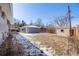 A spacious backyard features a shed and gray brick outbuilding providing ample space for outdoor activities at 5895 S Huron St, Littleton, CO 80120