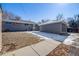 Large backyard featuring a detached two-car garage and a well-maintained lawn at 5895 S Huron St, Littleton, CO 80120