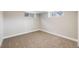 Neutral bedroom featuring two windows for natural light and plush neutral carpeting at 5895 S Huron St, Littleton, CO 80120