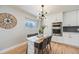 Elegant dining area featuring built-in appliances, a large window, modern light fixture, and stylish decor at 5895 S Huron St, Littleton, CO 80120