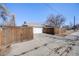 Spacious driveway leading to a two-car garage with a wooden privacy fence at 5895 S Huron St, Littleton, CO 80120