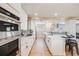 Modern kitchen featuring stainless steel appliances, sleek white cabinetry, and hardwood floors at 5895 S Huron St, Littleton, CO 80120