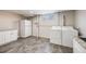 Basement laundry room featuring a white washer and dryer, cabinets, and granite counters at 5895 S Huron St, Littleton, CO 80120