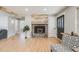 Spacious living room featuring a modern fireplace and an open floor plan with bright lighting at 5895 S Huron St, Littleton, CO 80120