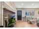 Cozy living room featuring a modern fireplace, hardwood floors, and a stylish black front door with glass accents at 5895 S Huron St, Littleton, CO 80120