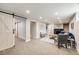 Finished basement living room with a modern fireplace and stylish barn doors at 5895 S Huron St, Littleton, CO 80120