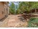A beautifully landscaped backyard featuring a stone patio with fire pit at 2908 Open Sky Way, Castle Rock, CO 80109