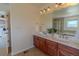 Bathroom featuring a double vanity, granite countertop, and access to the separate shower and soaking tub at 2908 Open Sky Way, Castle Rock, CO 80109