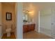 Contemporary bathroom with double sink vanity and views to the walk-in closet at 2908 Open Sky Way, Castle Rock, CO 80109