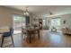 Open-concept dining area with a table and chairs, leading to a kitchen and a bright living space at 2908 Open Sky Way, Castle Rock, CO 80109