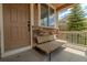 Welcoming front porch with a cozy bench, stone accents, and a stylish front door at 2908 Open Sky Way, Castle Rock, CO 80109
