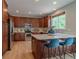 Beautiful kitchen featuring stainless steel appliances, wood cabinets, and an island with quartz countertops at 2908 Open Sky Way, Castle Rock, CO 80109