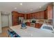 Bright kitchen with wooden cabinets, stainless appliances, a large island, and a view into the adjacent room at 2908 Open Sky Way, Castle Rock, CO 80109