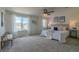 Spacious primary bedroom with a ceiling fan, plush carpeting, and large windows for natural light at 2908 Open Sky Way, Castle Rock, CO 80109