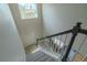 View of a carpeted staircase leading to a lower level, with a window providing natural light at 2908 Open Sky Way, Castle Rock, CO 80109
