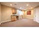 Finished basement with wet bar and carpet flooring at 911 Snowberry St, Longmont, CO 80503