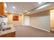 Finished basement recreation area with wet bar and carpet at 911 Snowberry St, Longmont, CO 80503