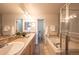 Bathroom with double vanity, soaking tub, and glass shower at 911 Snowberry St, Longmont, CO 80503