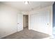 Well-lit bedroom with double door closet and access to hallway at 911 Snowberry St, Longmont, CO 80503