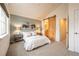 Main bedroom with vaulted ceiling, barn door to bathroom, and carpeted floor at 911 Snowberry St, Longmont, CO 80503