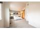 Spacious main bedroom with vaulted ceiling, barn door, and en suite bathroom at 911 Snowberry St, Longmont, CO 80503