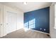 Bedroom with blue accent wall and carpet flooring at 911 Snowberry St, Longmont, CO 80503