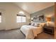 Bright bedroom with vaulted ceiling, large window, and carpeted floor at 911 Snowberry St, Longmont, CO 80503