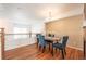 Bright dining room with hardwood floors and a four-person table at 911 Snowberry St, Longmont, CO 80503