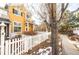 Inviting townhome exterior with a charming white picket fence at 911 Snowberry St, Longmont, CO 80503