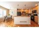 Eat-in kitchen with island, wood cabinets, and a view to dining area at 911 Snowberry St, Longmont, CO 80503