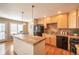 Modern kitchen with light wood cabinets, tile backsplash, and stainless steel appliances at 911 Snowberry St, Longmont, CO 80503