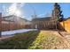 Backyard with detached garage, wooden fence, and grassy area at 2068 Jasmine St, Denver, CO 80207