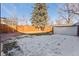Large backyard with detached garage, wooden fence, and patio at 2068 Jasmine St, Denver, CO 80207