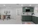 Basement kitchenette with green cabinets and quartz countertops at 2068 Jasmine St, Denver, CO 80207