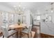 Elegant dining area with a round wooden table and chandelier at 2068 Jasmine St, Denver, CO 80207