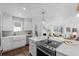 Bright, modern kitchen features stainless steel appliances, large center island, and open floor plan at 2068 Jasmine St, Denver, CO 80207